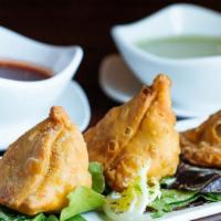 Vegetable Samosa ( Vegan ) · Fried turnovers filled with potatoes, green peas, and nuts.