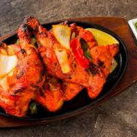 Tandoori Chicken · Gluten free. Spicy. Whole chicken marinated in yogurt, ginger, garlic & spicies. Grilled