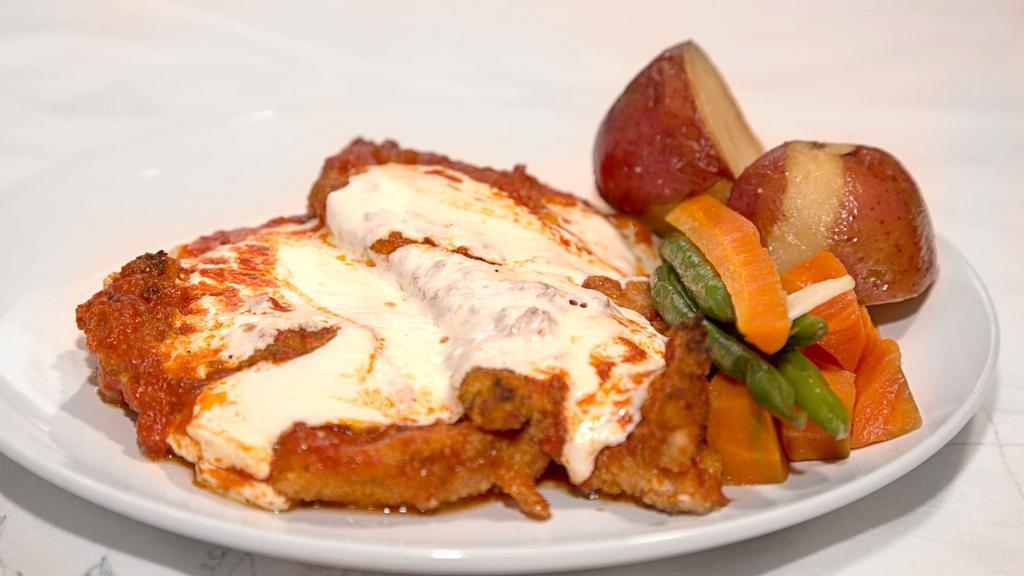 Chicken Parmigiana · Lightly breaded breast of chicken topped with marinara sauce and fresh Mozzarella cheese.