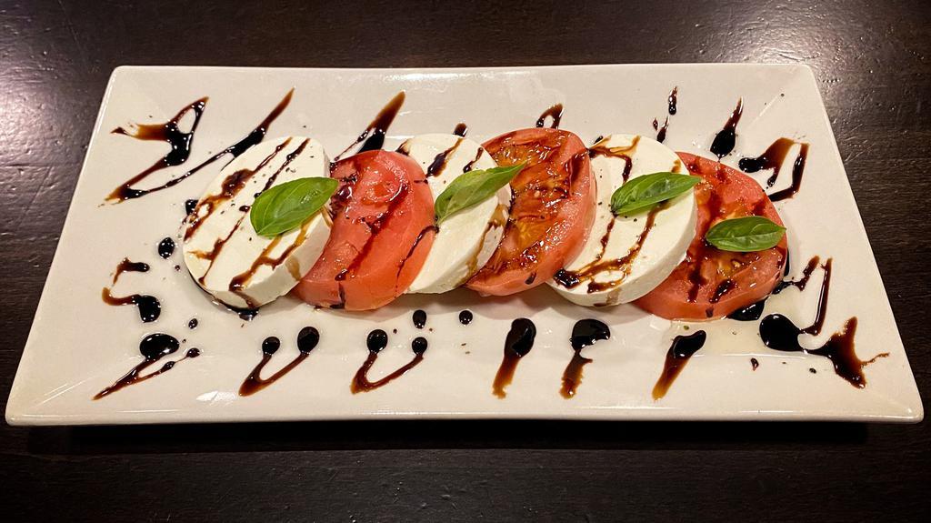 Caprese · Gluten free. Mozzarella and sliced tomatoes topped with balsamic vinegar, extra virgin olive oil and fresh basil.