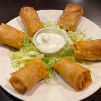 Buffalo Chicken Spring Rolls · Stuffed with buffalo chicken, Monterey jack cheese, and cilantro. Served with blue cheese.