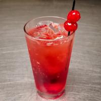 Shirley Temple · Ginger ale and a splash of grenadine, garnished with a maraschino cherry.