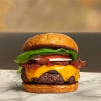 Bring Home The Bacon Burger · American beef patty topped with melted cheese, layers of crispy bacon, lettuce, tomato, onio...