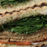 Capri · Breaded eggplant with roasted peppers, fresh mozzarella, fresh spinach leaves and a pesto ba...