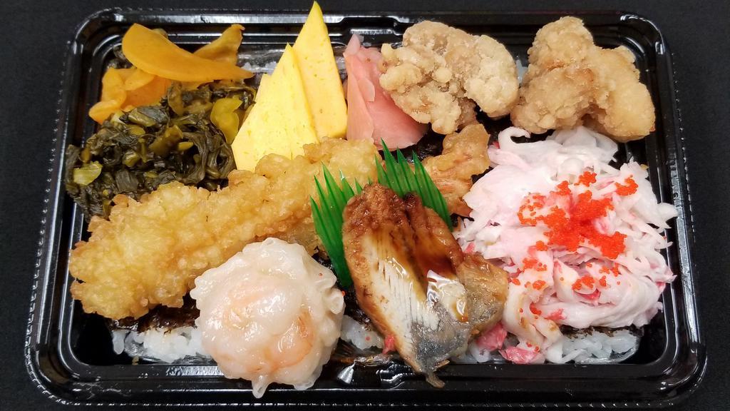 Sushiman Bento B · Shrimp tempura, Karaage, Egg, Crab, Shrimp shumai, Unagi, Pickles.