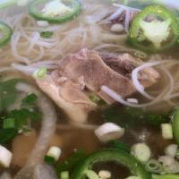 Oxtail Pho / Phở Đuôi Bò · 8 oz of slow cooked lean cut oxtail, savory ginger beef broth. Garnished with round onion, g...