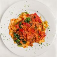 Pappardelle Cavolo, Pomodorini Secchi E Salsiccia · Long wide cut pasta with kale, sun-dried tomatoes, and sausage, in a light tomato sauce.
