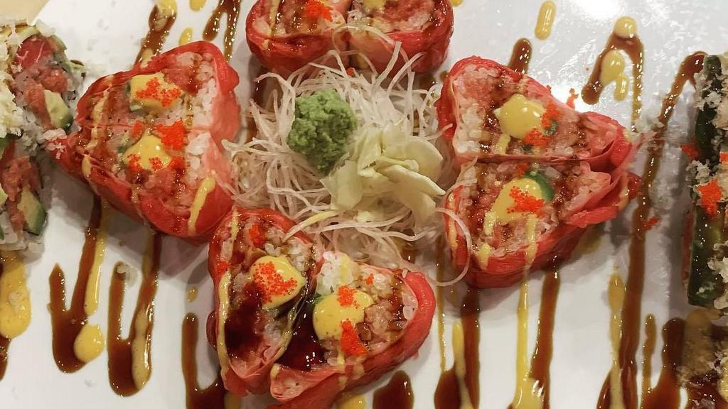 Sweet Heart Roll · Spicy tuna and avocado wrapped in soy paper, topped with tuna and chefs special sauce, red tobiko.