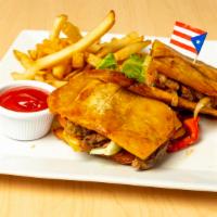 El Jibarito · Choice of pork, steak or chicken creole, and cheddar cheese, sandwiched between two fried pl...