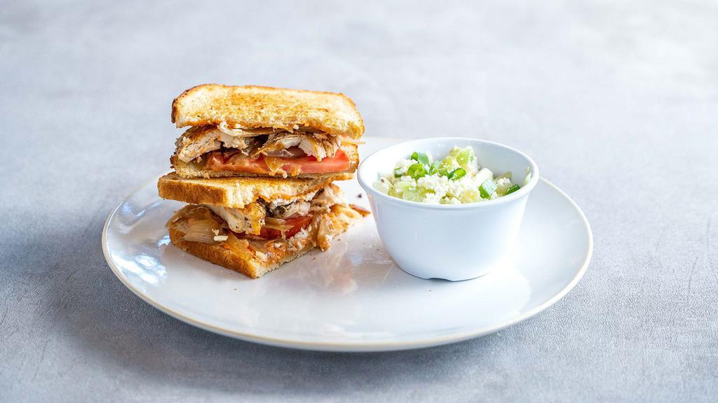 Spicy Grilled Chicken Sandwich · Grilled chicken, feta, caramelized onions, tomatoes, and Spicy Aioli on sourdough bread.