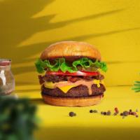 Vegan Classic Burger · Seasoned plant-based patty patty topped with lettuce, tomato, and onions. Served on a warm b...