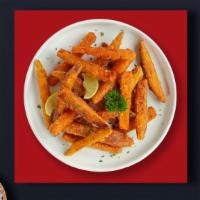Sweet Potato Fries · Thick-cut sweet potato wedges fried until golden brown