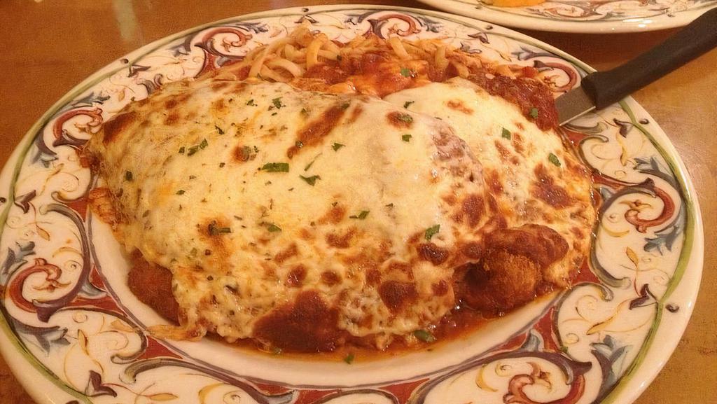 Chicken Parmigiana · Breaded chicken cutlet, topped with tomato sauce and mozzarella cheese, baked and served with pasta choice.
