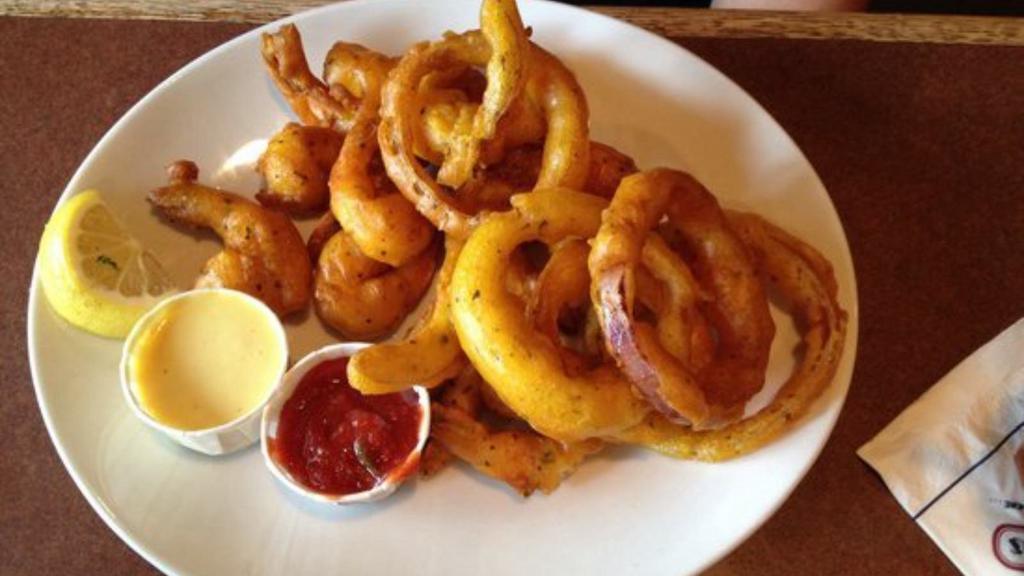 Fried Shrimp & Onion Rings With Lemon Pepper Sauce · A generous portion of Hot N' Fresh Fried Shrimp, served on a bed of onion rings. Served with Lemon Pepper sauce.