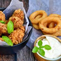 Classic Chicken Tenders Basket With Onion Rings · Delicious chicken tenders battered and fried to perfection. Served on a bed of Onion Rings.