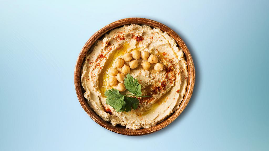 Easy Hummus · Chickpeas boiled till soft, mashed, blended, and mixed with garlic, tahini sauce, olive oil, and fresh lemon juice.