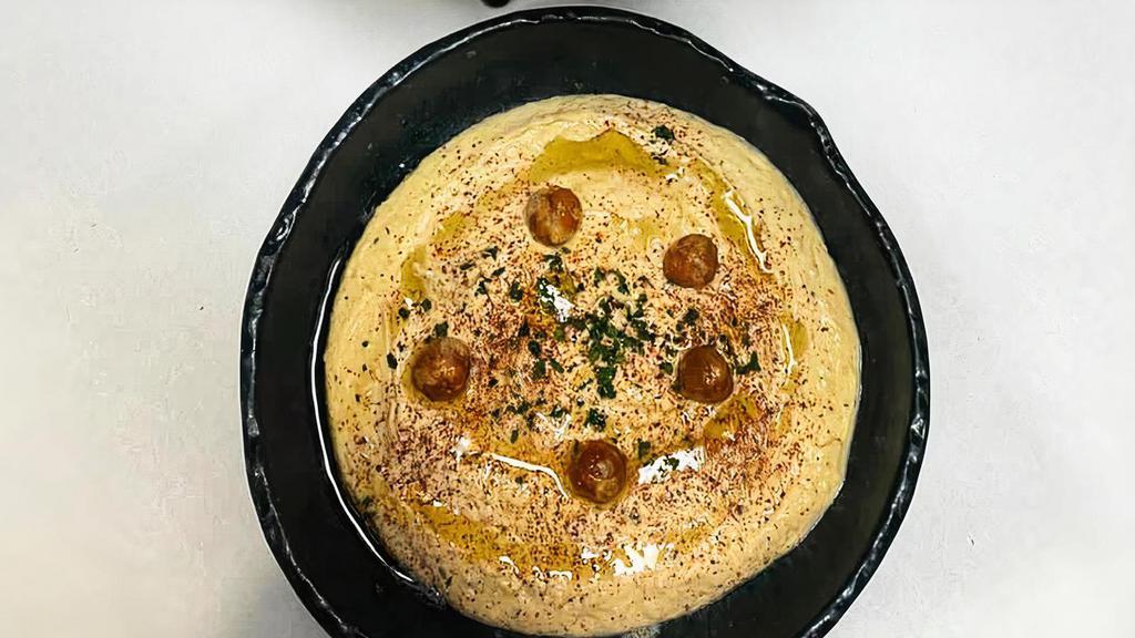 Mediterranean Hummus · Olive oil, sumac, served with freshly baked pita.