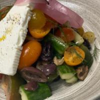 Greek Salad · Heirloom tomatoes, olives, cucumbers, pickled onions, sheep milk feta.