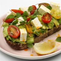 Avocado Smash · fresh avocado, marinated feta, heirloom tomatoes + fresno chili oil on thick-cut toasted mul...
