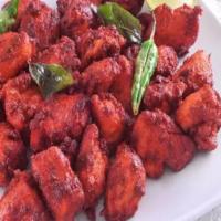 Chicken 65 · Spicy. Chicken fritters tossed in a fiery red chili and yogurt sauce.
