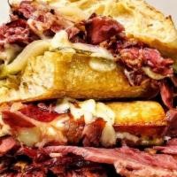Cuban Reuben · house smoked corned beef, manchego cheese, mustard-mayonnaise, pickles, ciabatta, served wit...