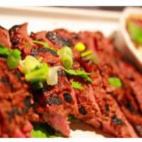 Bbq Flank Steak · Slices of charbroiled flank steak thai style with thai spices chili sauce.