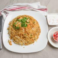 Chicken Dum Biriyani · Spiced tender boneless chicken cooked with basmati rice, herbs, fruits, and nuts.