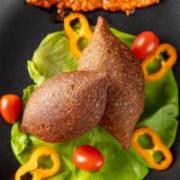 Two Piece Kibbeh · Bulgur balls stuffed with sauteed ground beef and nuts. Served with white sauce.