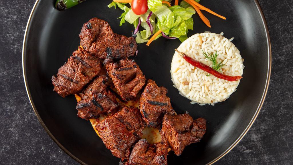 Lamb Shish Kebab · Charcoal broiled tender cubes of lamb marinated with our chef's seasoning. Served with rice, garnish, and grilled hot pepper.