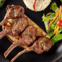 Lamb Chops · Baby lamb chops broiled to your taste. Served with rice, garnish, and grilled hot pepper.