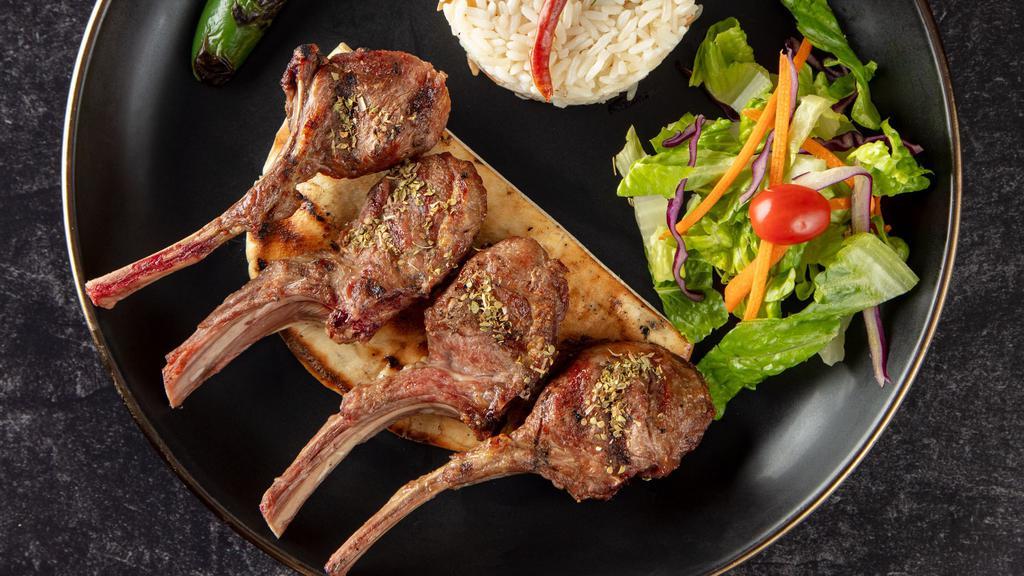 Lamb Chops · Baby lamb chops broiled to your taste. Served with rice, garnish, and grilled hot pepper.