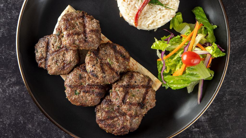 Kofte Kebab · Parsley, white onion and cumin get together with ground beef. Served with rice, garnish, and grilled hot pepper.