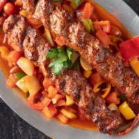 Has Has Kebab · Skewered ground lamb on a bed of special tomato sauce. Served with rice.
