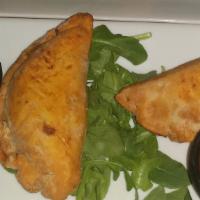 Beef Empanadas · Stuffed with dried cranberries. Served with a side of avocado crema and chipotle southwest s...
