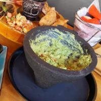 Guacamole En Molcajete · Freshly made guacamole with avocado, jalapeno, tomato, onion, cilantro, and homemade tortill...