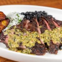Churrasco Latino · Grilled Skirt Steak Served with rice, black beans, sweet plantains, and cilantro chimichurri...