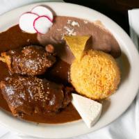 Mole Con Pollo · Chicken on the bone in mole sauce. Served with rice, beans and fresh Mexican cheese.