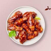 Bbq Boy Wings · Fresh chicken wings breaded, fried until golden brown, and tossed in barbecue sauce. Served ...