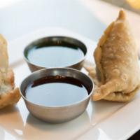 Vegetable Samosa · Delicately spiced potatoes & peas wrapped in a crispy pastry.