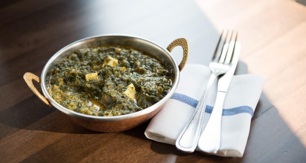 Saag Paneer · Cubes of homemade cheese smothered in freshly ground spinach.