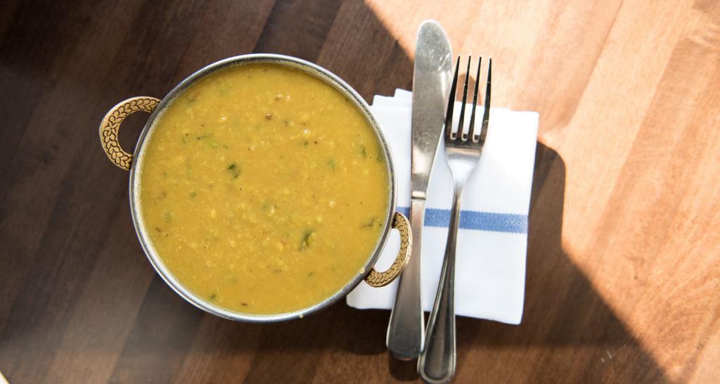 Yellow Tadka Dal · Simmered yellow lentils tempered with ginger, garlic, cumin seeds & diced tomatoes.