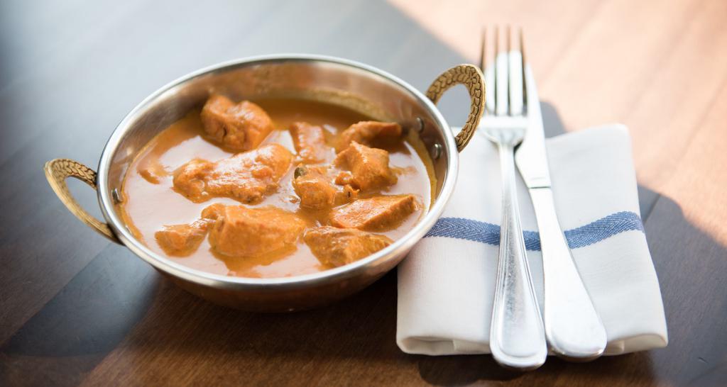 Chicken Tikka Masala · Marinated cubes of chicken grilled in tandoor oven & simmered in a mild creamy tomato sauce.