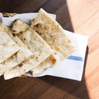 Garlic Naan · Leavened white flour bread brushed with fresh chopped garlic and cilantro.