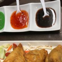Chicken Samosa · Crispy turnovers with delicately spiced chicken, served with mint and tamarind chutney.