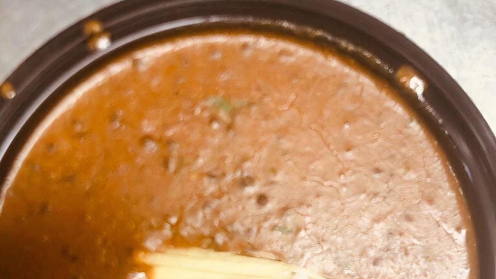 Dal Makhani · A delicious preparation of black lentils simmered overnight with onions, butter and tomatoes finished with light cream and herbs.