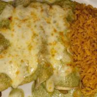Enchiladas De Pollo En Mole Verde / Chicken Enchiladas In Green Mole · With melted cheese on the enchiladas, serving with yellow Mexican rice and refried beans.