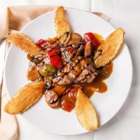 Porterhouse Pork Chop · With sausage, hot and sweet cherry peppers, crispy potatoes in a spicy savory sauce.
