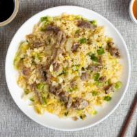 Beef Fried Rice · Juicy beef and veggies pan fried and cooked with rice.
