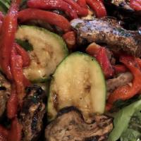 Grilled Vegetable Salad · Grilled zucchini, eggplant, and roasted red peppers marinated in balsamic vinegar served ove...