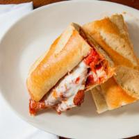 Chicken Parmigiana · Breaded chicken cutlet topped with tomato sauce & melted mozzarella (served with spaghetti o...